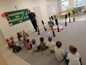 grupa dzieci patrząca na policjanta